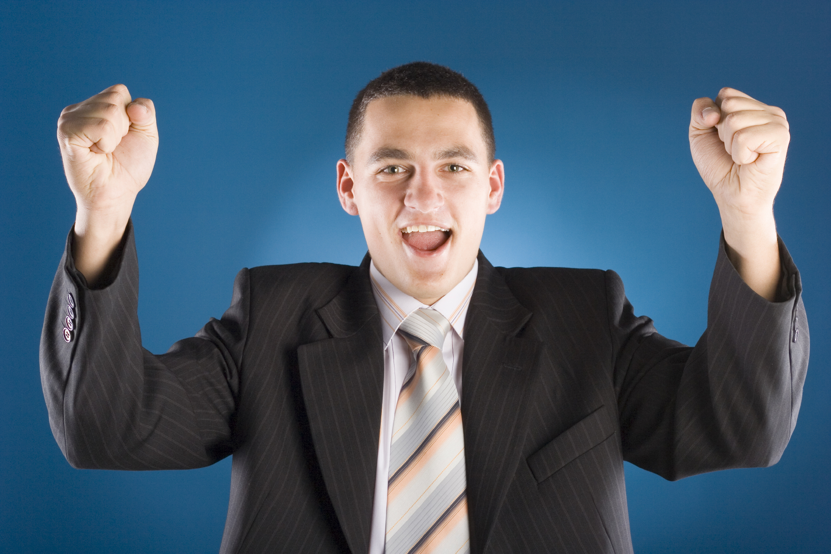 successful businessman with both hands up